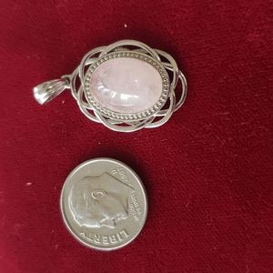 Pink pendant with silver detail.